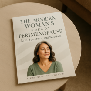 A magazine titled “The Modern Woman’s Guide to Perimenopause” featuring a calm, mature woman on the cover, resting on a light wooden coffee table. The design uses soft, natural colors aligned with New Beginnings Wellness Clinic branding.