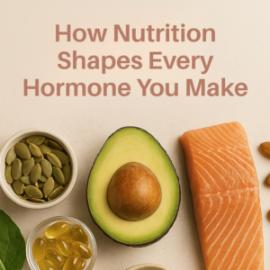 A flat-lay image featuring an avocado, salmon, pumpkin seeds, supplements, and leafy greens, with the text “How Nutrition Shapes Every Hormone You Make.” The image highlights the connection between nutrient-rich foods and hormone production in alignment with New Beginnings Wellness Clinic branding.
