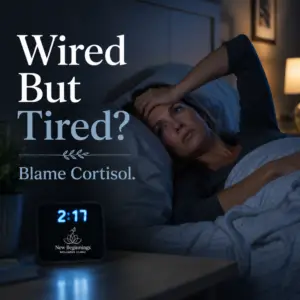A woman lying awake in bed at 2:17 AM looking exhausted and frustrated. Text overlay from New Beginnings Wellness Clinic reads "Wired But Tired? Blame Cortisol."