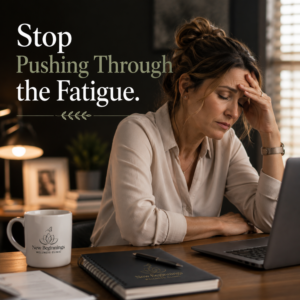 Woman with hand on forehead, eyes closed, looking stressed at a desk with a laptop and a 'New Beginnings' mug.
